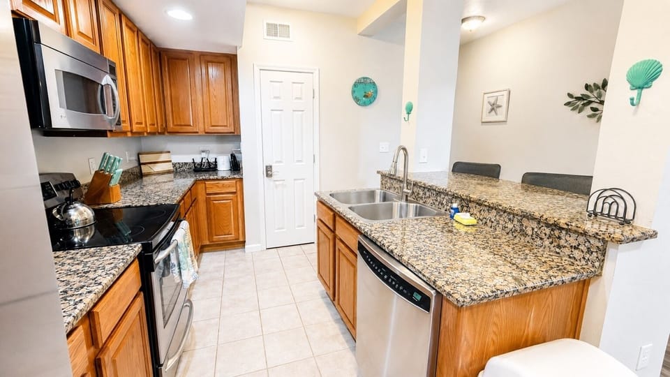 Modern Coastal Kitchen - Spacious kitchen with granite countertops and stainless appliances.