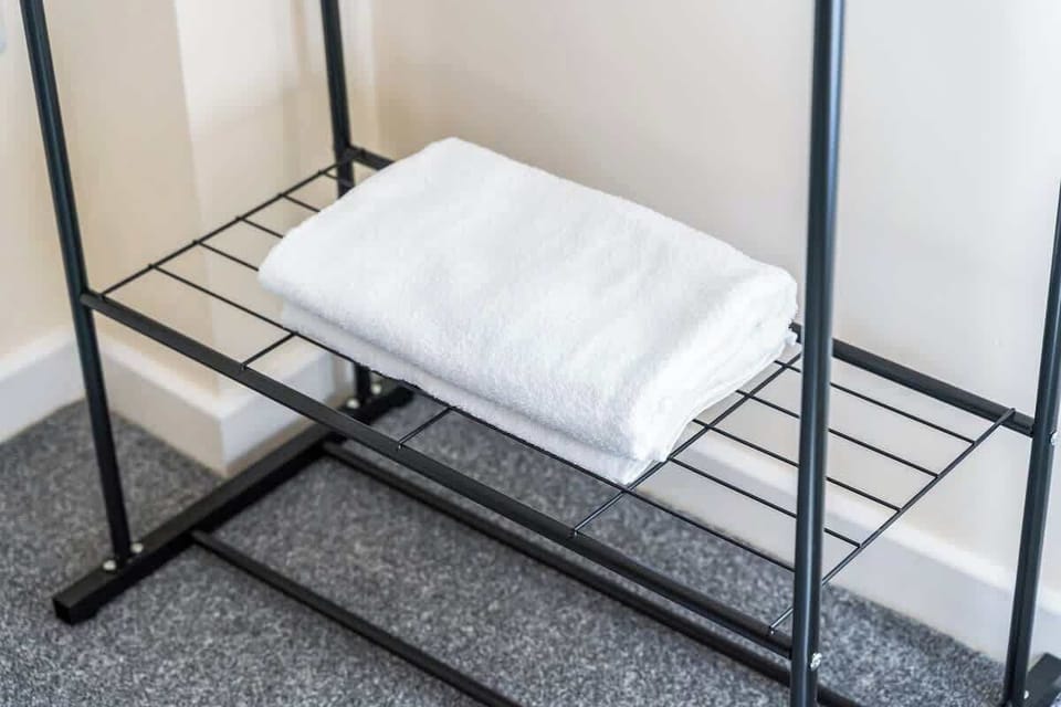 Modern twin-bedded room with plush single beds, soft linens, and a calm color palette. The room is bright, well-kept, and ideal for guests looking for comfort and convenience.