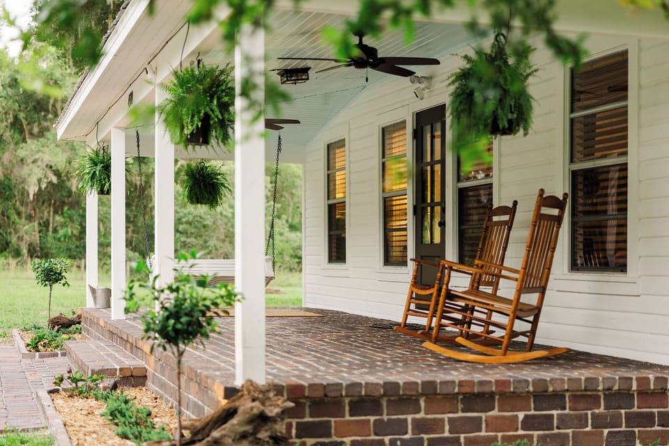 Front porch mornings - rocking chairs, hanging ferns, and birdsong.