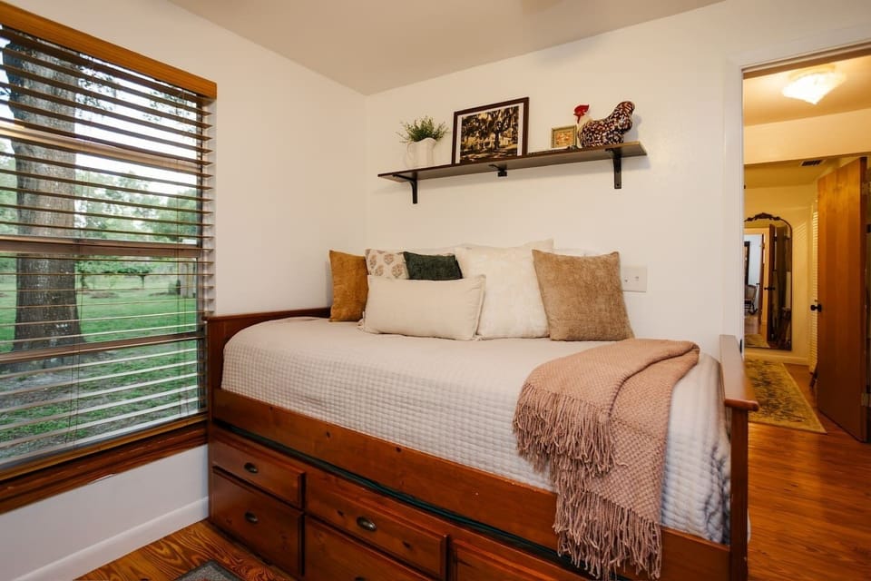 A trundle bed with garden view. 