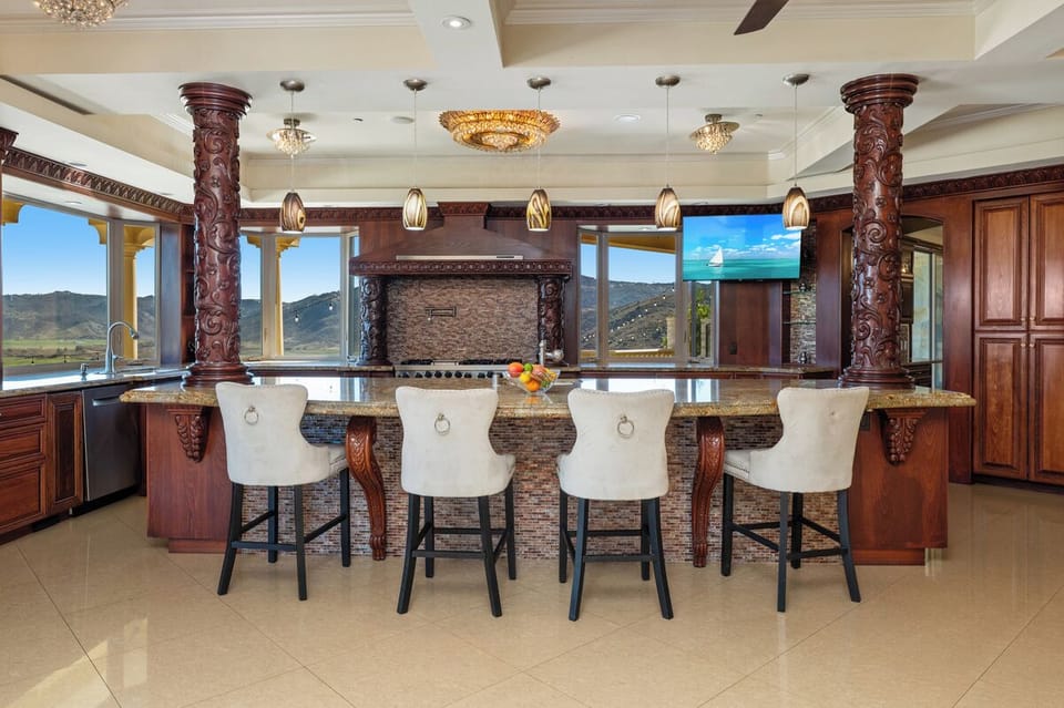 Under a coffered ceiling, the island naturally becomes the heart of the kitchen.