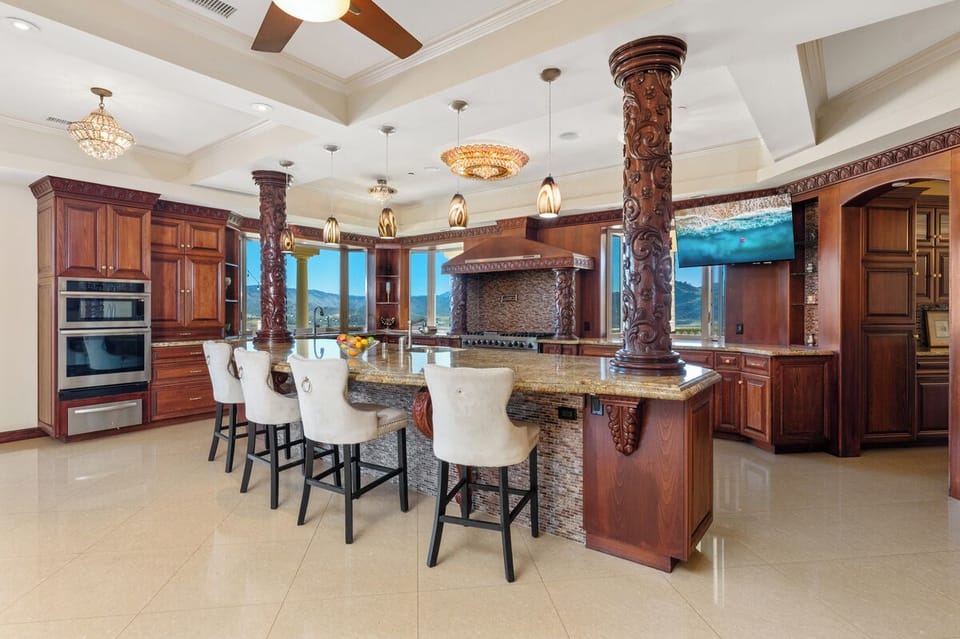 Pull up to the granite bar while dinner comes together across the island.