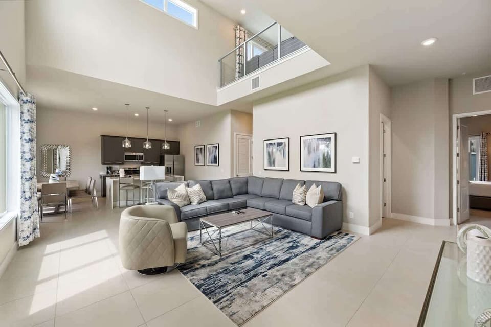 Unit 222 Living Room: Soaring ceilings and floor-to-ceiling light create an expansive space to gather everyone together.