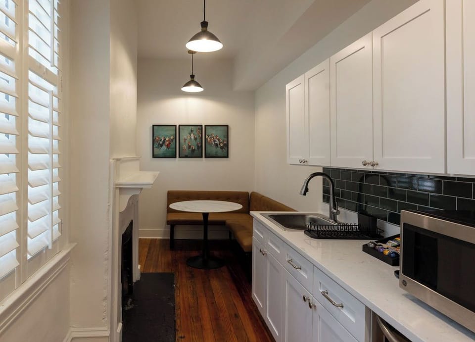 Bright kitchenette with cozy banquette dining nook and stylish finishes