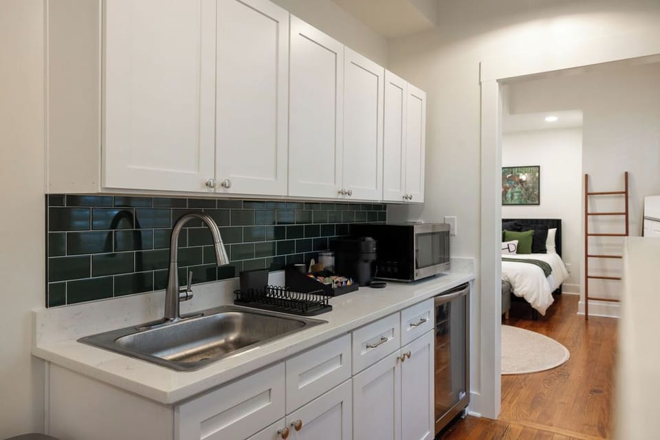 Stylish kitchenette with beverage fridge and easy access to the bedroom