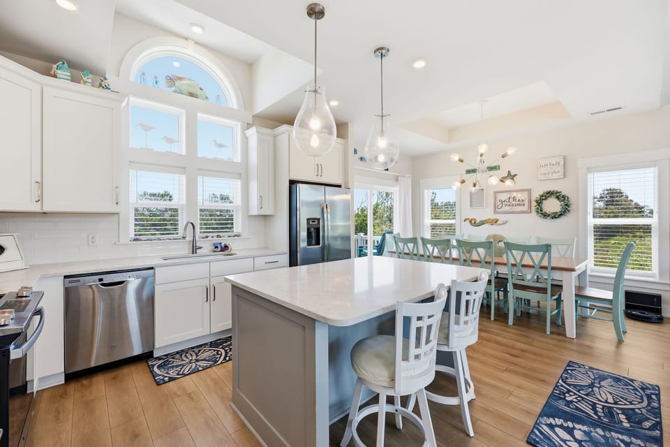 Spacious open-concept kitchen and dining area featuring a large island with seating