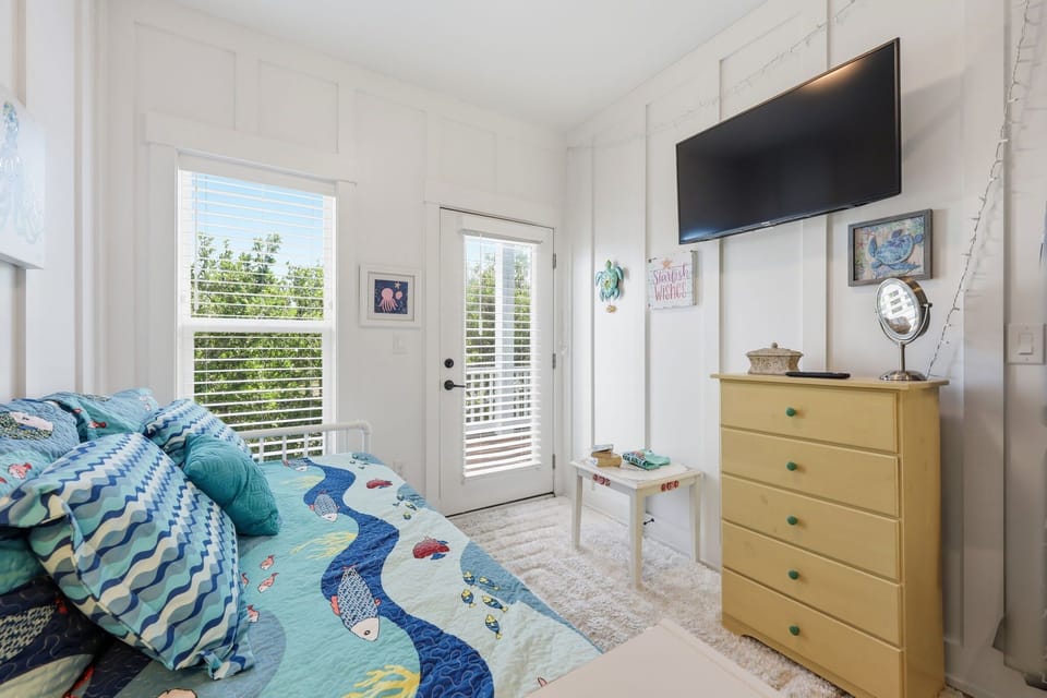 Mid Level: Den with a daybed, a TV, dresser, and easy access to the outdoor deck