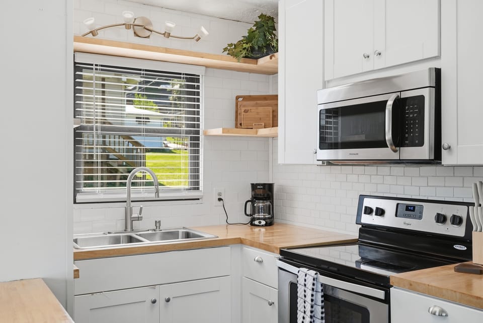 Bright modern kitchen with butcher block counters and sunny window views