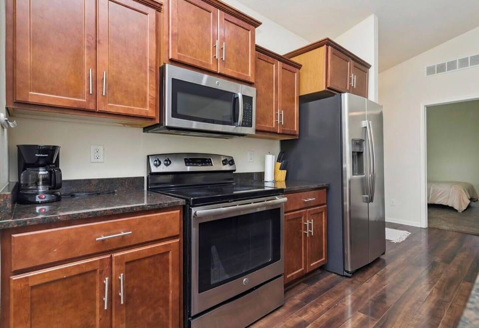 Modern kitchen with stainless appliances, ample storage, and warm wood finishes