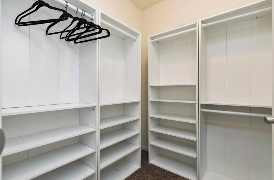 Spacious walk-in closet with built-in shelving and plenty of storage