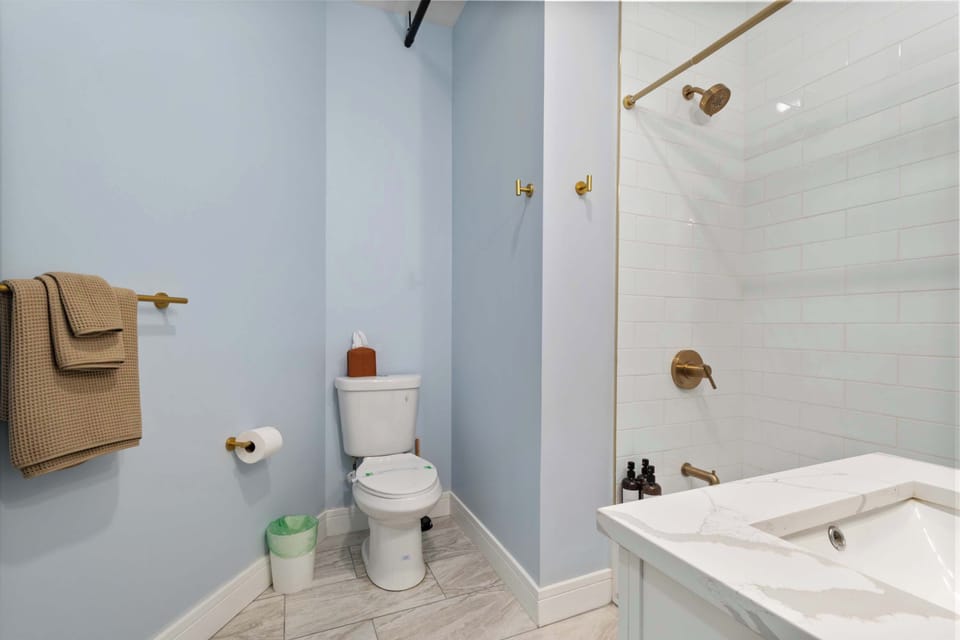 Tub/shower combo w/ towel bar, ready for a relaxing soak.