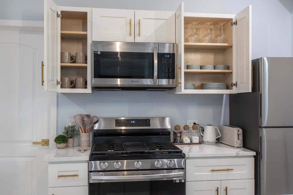 Handy microwave & open shelving keep the kitchen functional.