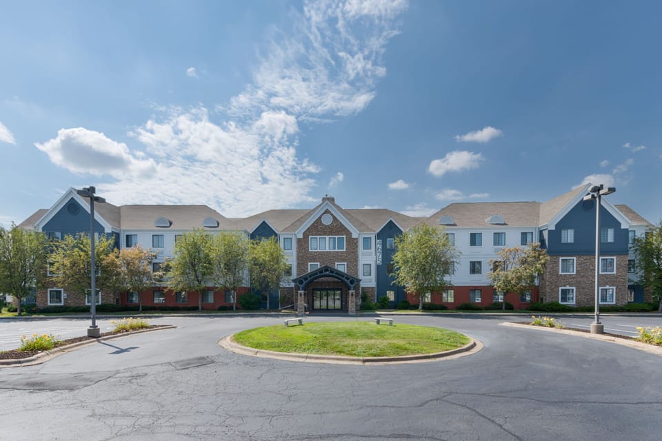 Pull into the circular drive framed by landscaped beds and covered walkways at the main entrance.