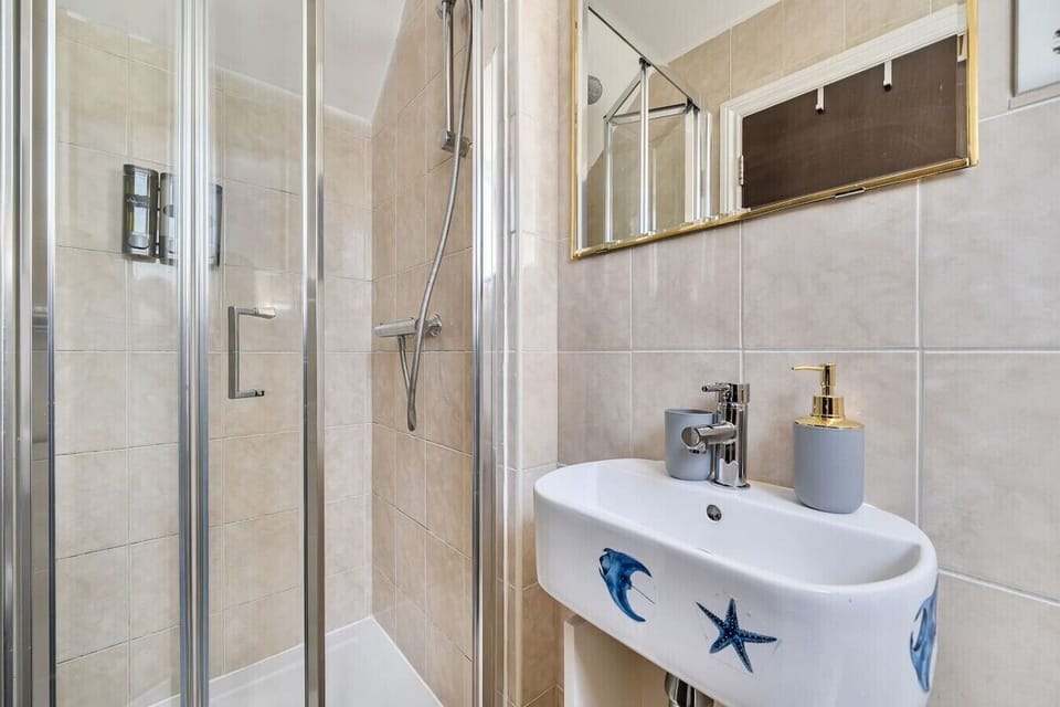 Clean walk-in shower with playful seaside touches