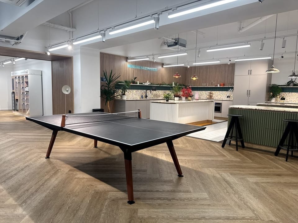 Modern lounge with ping pong table and designer kitchen hangout