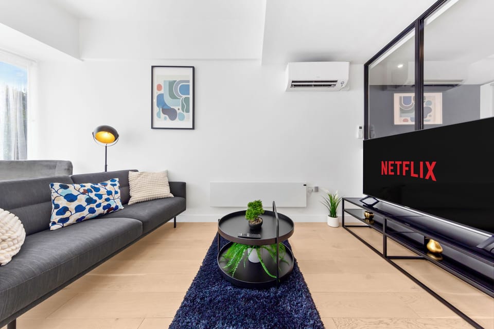 Bright modern lounge with Netflix, AC, and stylish cozy seating