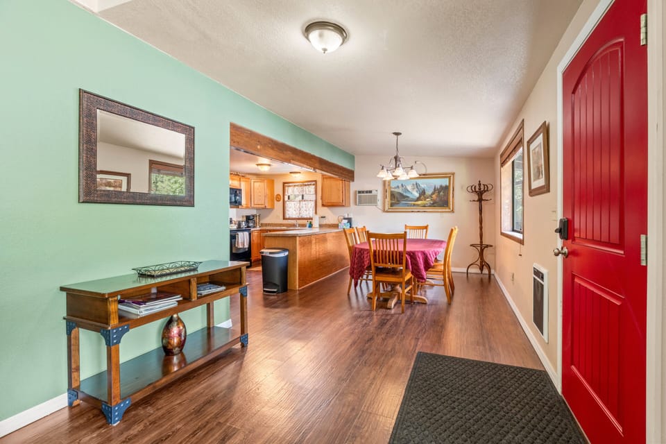 View of front door and entryway, looking toward the kitchen and dining area.