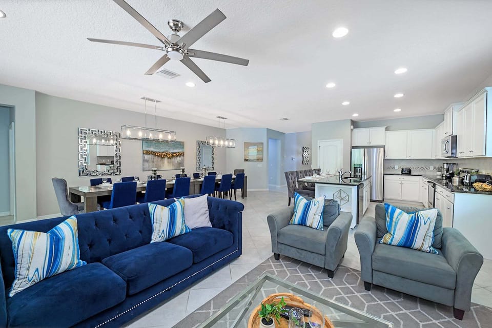 The open-plan family room offers comfortable seating, a large Smart TV, and direct access to the pool deck. It's the perfect gathering space for movie nights, relaxing after the parks, or spending quality time together.