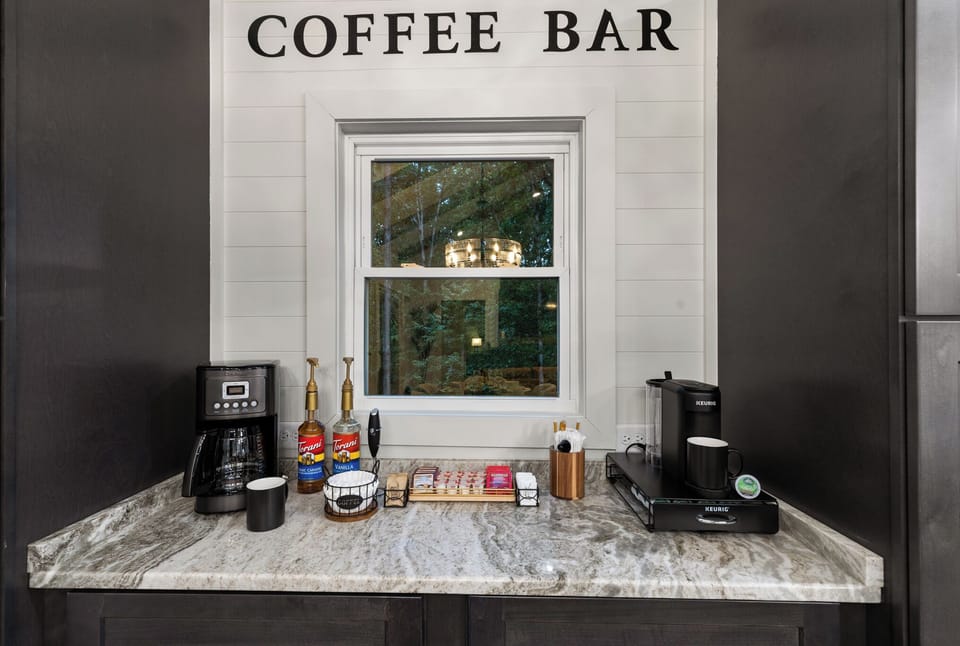 But First - Coffee, including a regular drip, Keurig, creamers, sugar, + syrups 