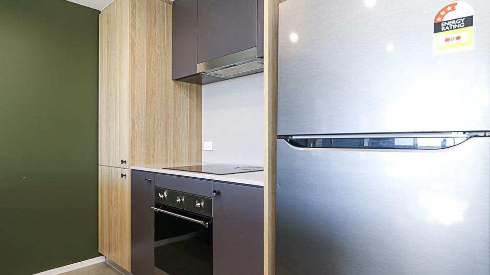 Full-size fridge, built-in oven, and ample kitchen storage.