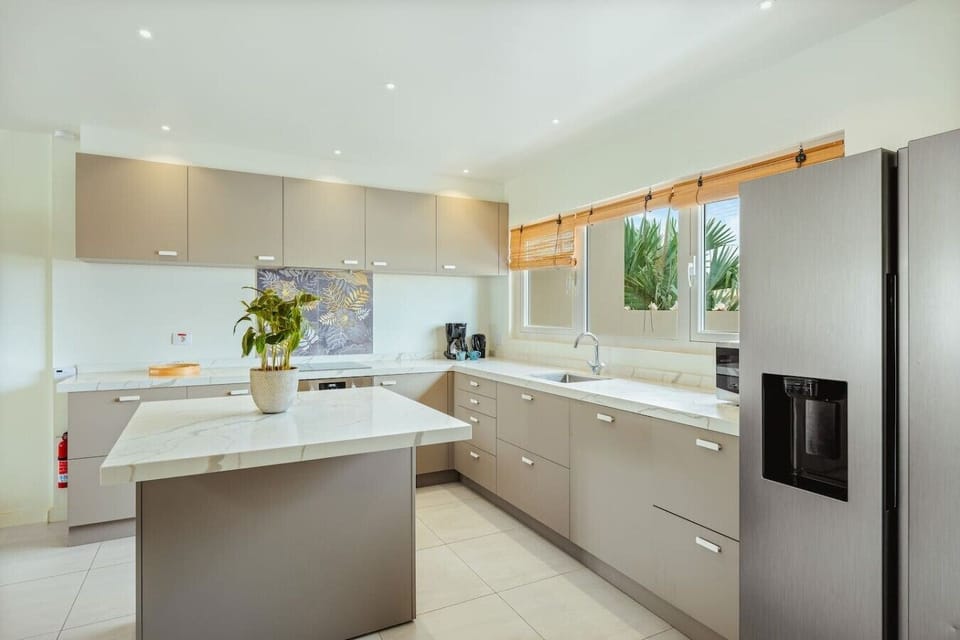 The fully equipped kitchen includes full-size appliances, generous counter space, and a large island that`s perfect for meal prep or casual breakfasts.