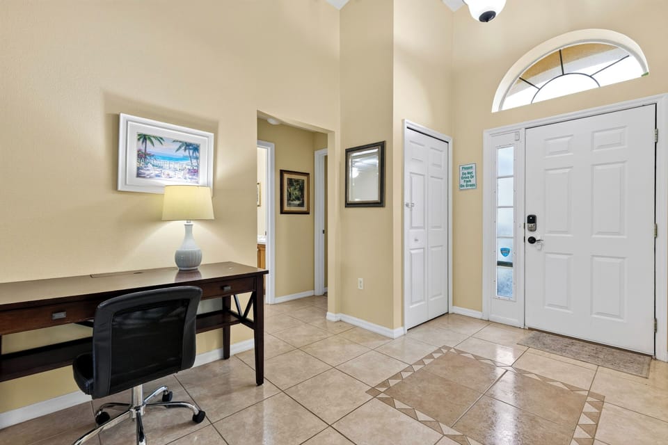Dedicated workstation desk tucked near the entryway for convenient remote work or studying.