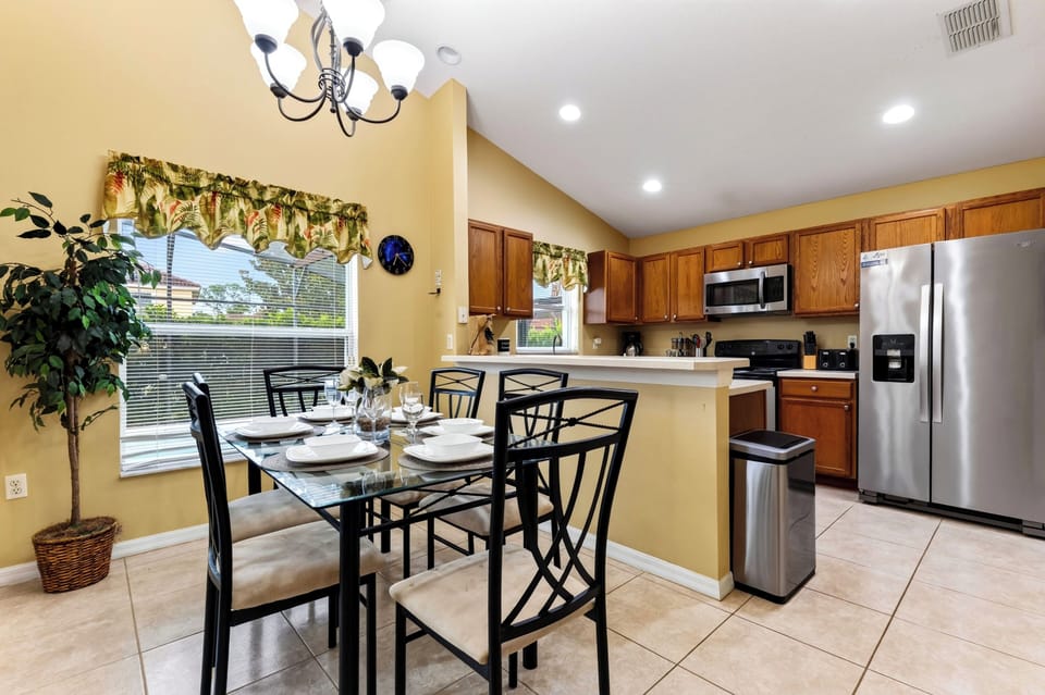 Dining area and kitchen breakfast bar combination, ideal for casual family meals.