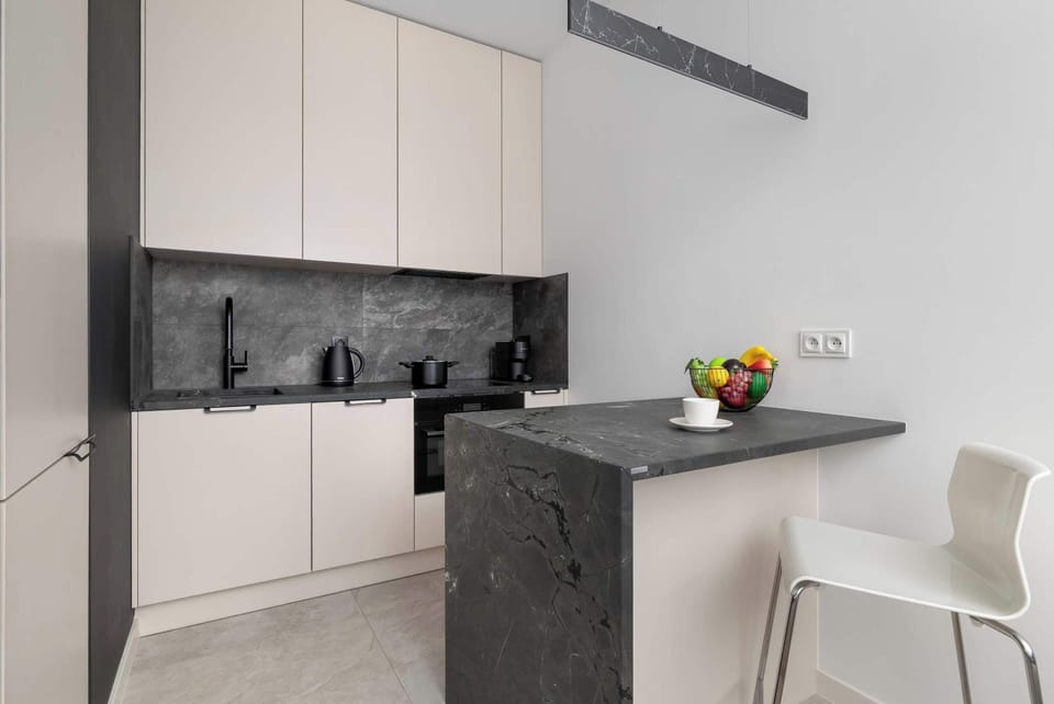 Modern and functional kitchenette with sleek cabinets and contemporary appliances.