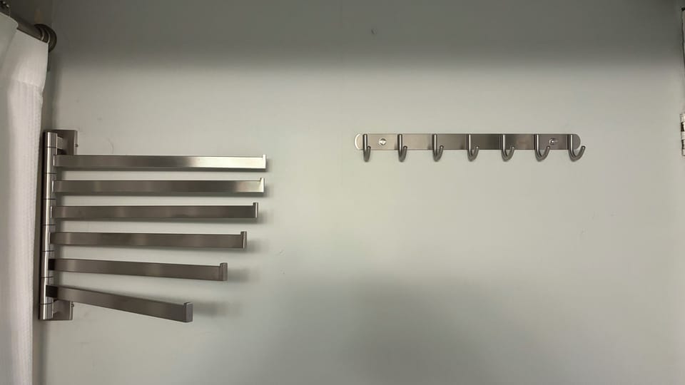 More than adequate towel racks and hooks in bathroom.
