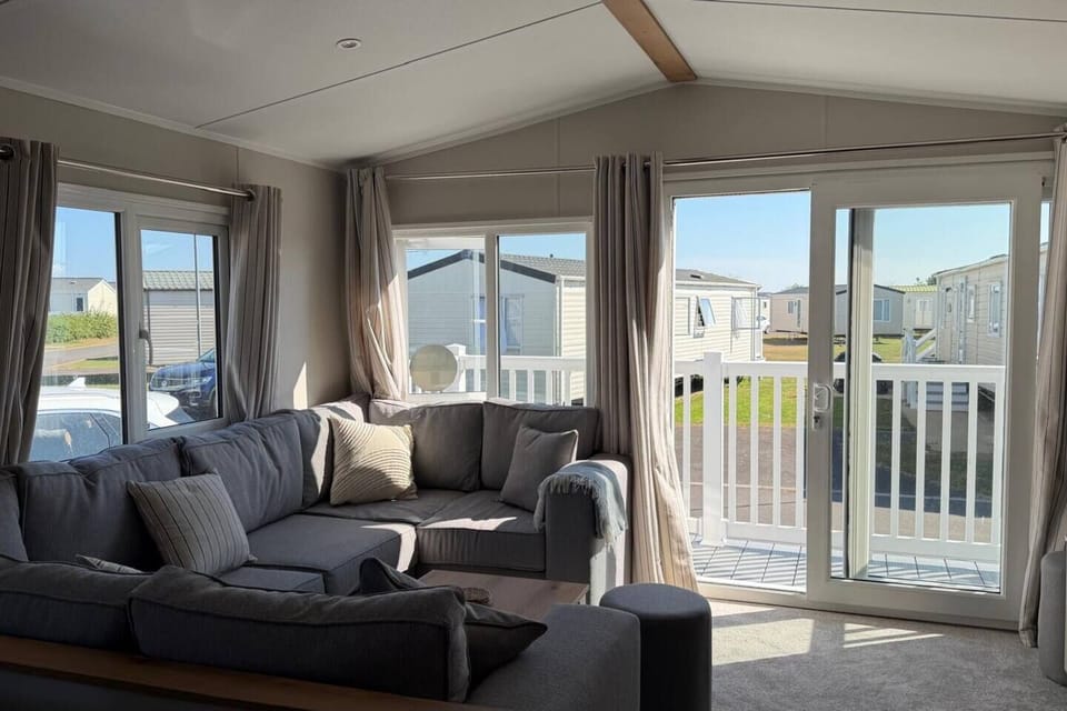 Large patio doors fill the lounge with natural light and open onto the  south facing decking.