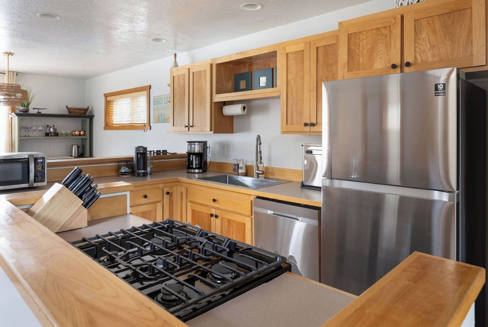 Kitchen with new stainless steel appliances and  gas range.