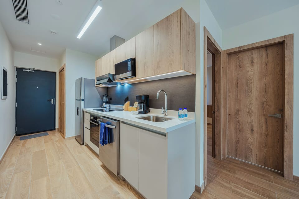 Step into your fully equipped kitchen with sleek modern appliances, ample counter space, and thoughtful touches like under-cabinet lighting. Everything you need to prepare meals and feel right at home during your stay.