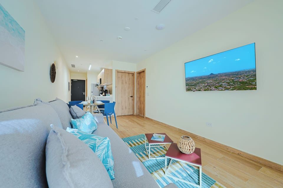 Step into your bright, airy retreat where coastal hues meet modern comfort. Relax on the plush sofa, dine at your table, and enjoy the open-concept flow from living room to kitchenette—your perfect home base.