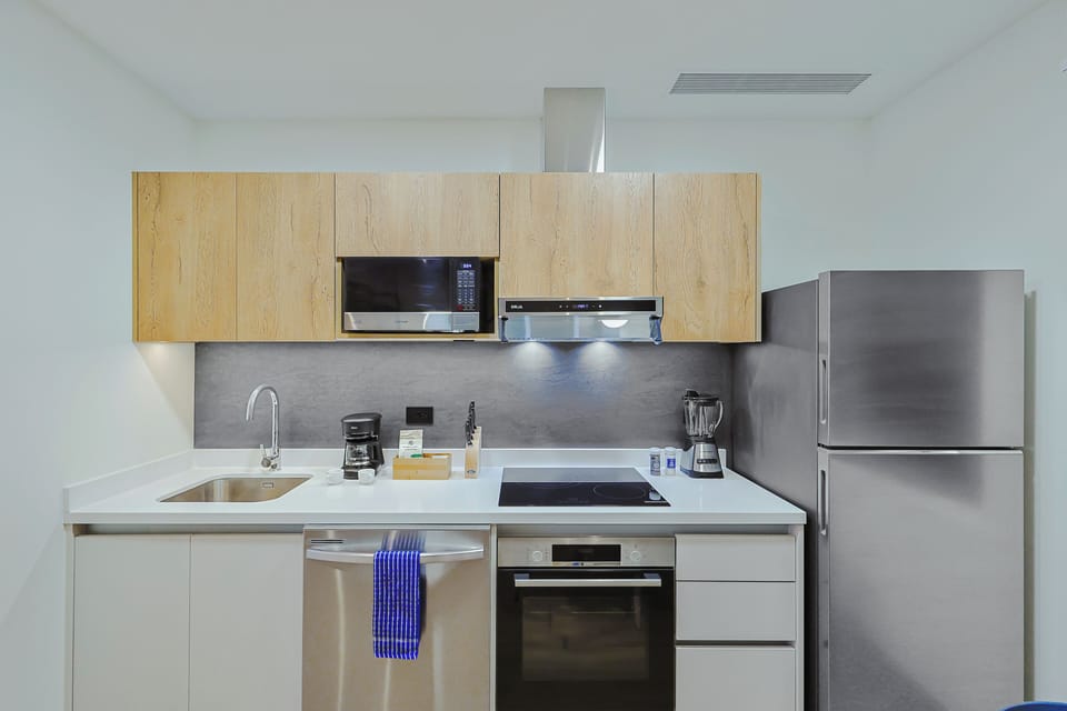 Your modern kitchen awaits with sleek stainless appliances, smooth countertops, and all the tools you need to whip up meals or morning coffee during your stay.