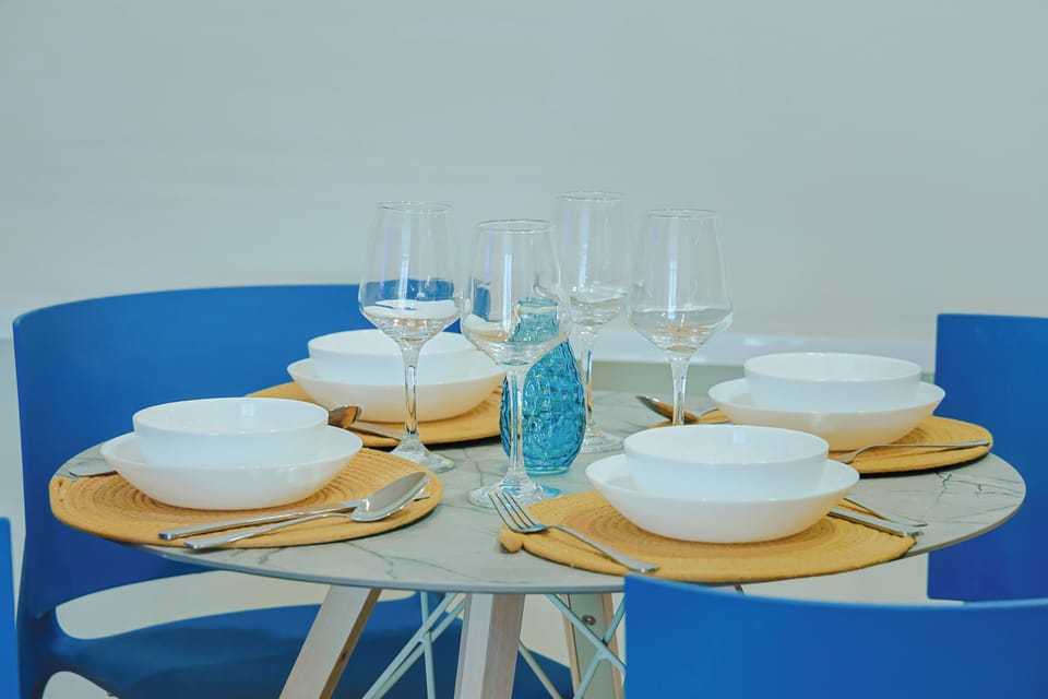 Gather around this beautifully set table where your memorable vacation meals await. Fresh linens, sparkling glassware, and charming coastal touches create the perfect setting for dining together.