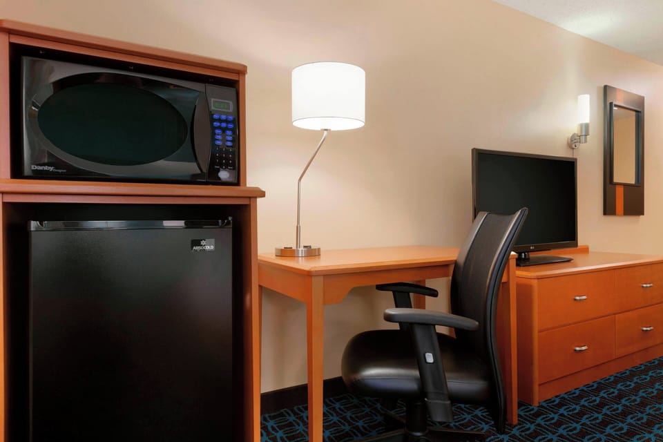Premium bedding, desk, laptop workspace, blackout drapes