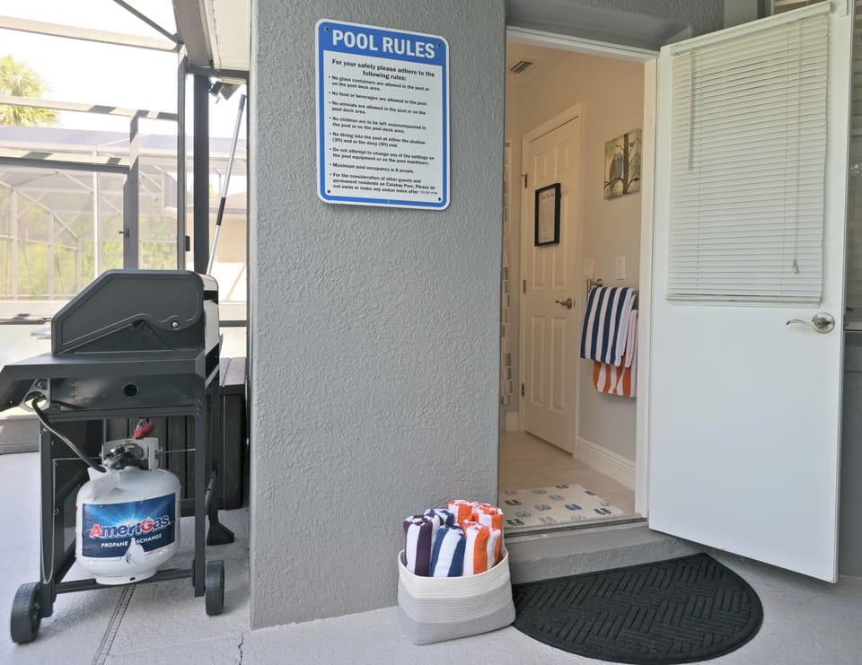 Easy pool access with screened lanai entry and convenient outdoor grill
