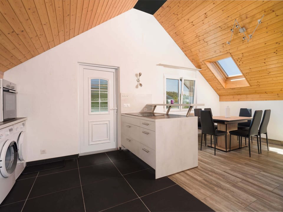 Open-plan kitchen and dining area with modern appliances and plenty of natural light.
