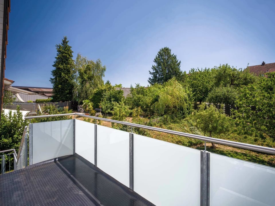 Private balcony overlooking the surrounding greenery.
