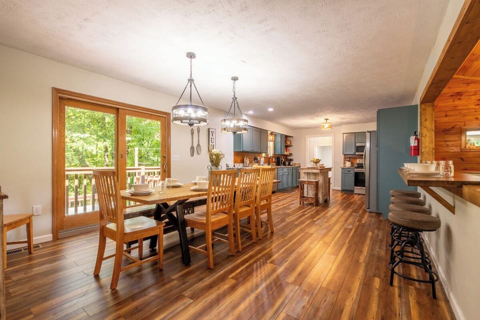 Gather around the spacious dining table with family and friends, where warm wood tones and abundant natural light create the perfect setting for memorable meals together.