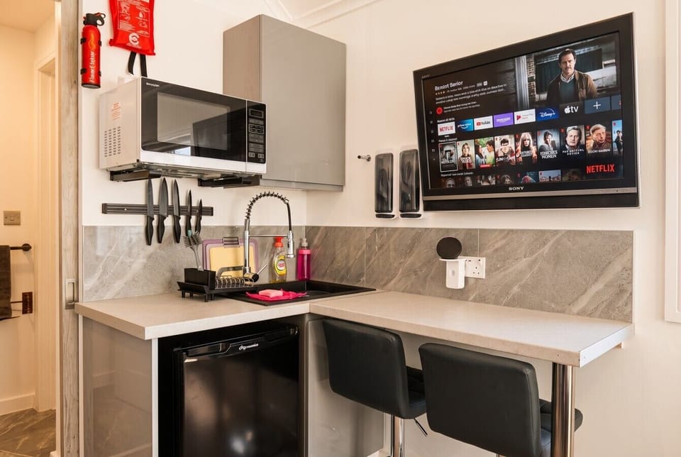 Compact kitchenette with microwave, sink and Smart TV for cosy nights in.