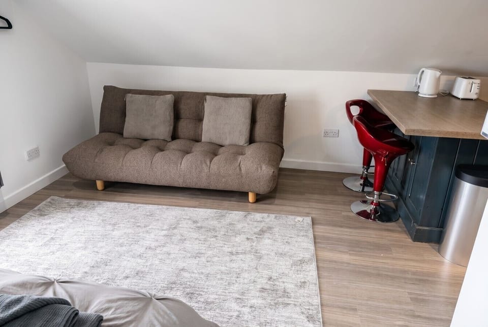 Sink into the cosy sofa in this bright open-plan studio retreat