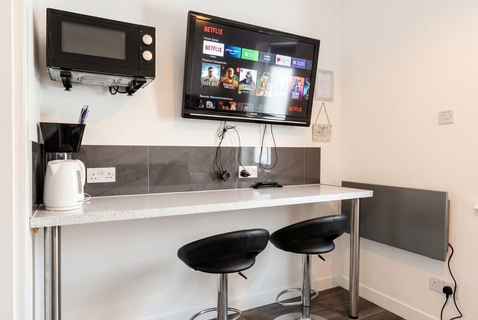 Compact kitchenette bar with microwave and smart TV
