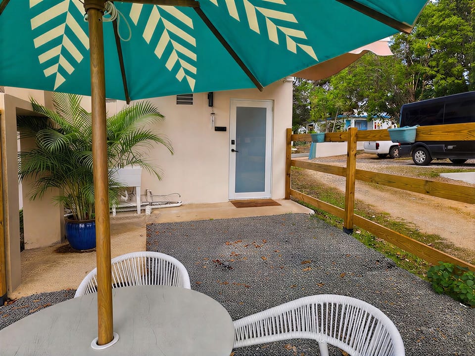 Private shaded patio with tropical touches and outdoor seating
