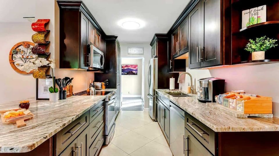 A fully stocked, modern-style kitchen with sleek appliances and all the essentials, perfect for preparing meals with ease and style.