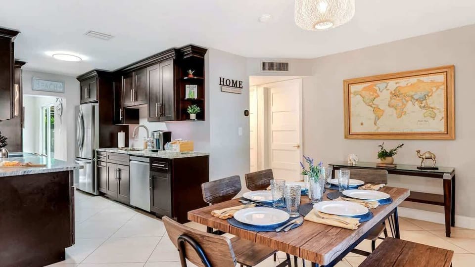 Spacious dining room with a sleek table, perfect for family meals or gathering with friends in a comfortable setting.
