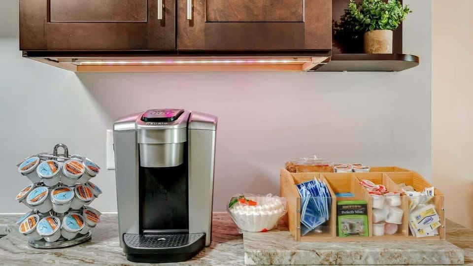 A convenient coffee maker with a selection of coffee and hot cocoa pods, ensuring you can enjoy your favorite warm drinks anytime.
