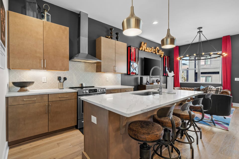 Fully equipped kitchen with island and bar seating.