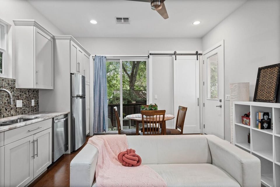 Open living, dining, and kitchen with a sliding door to the balcony keeps everyone together.