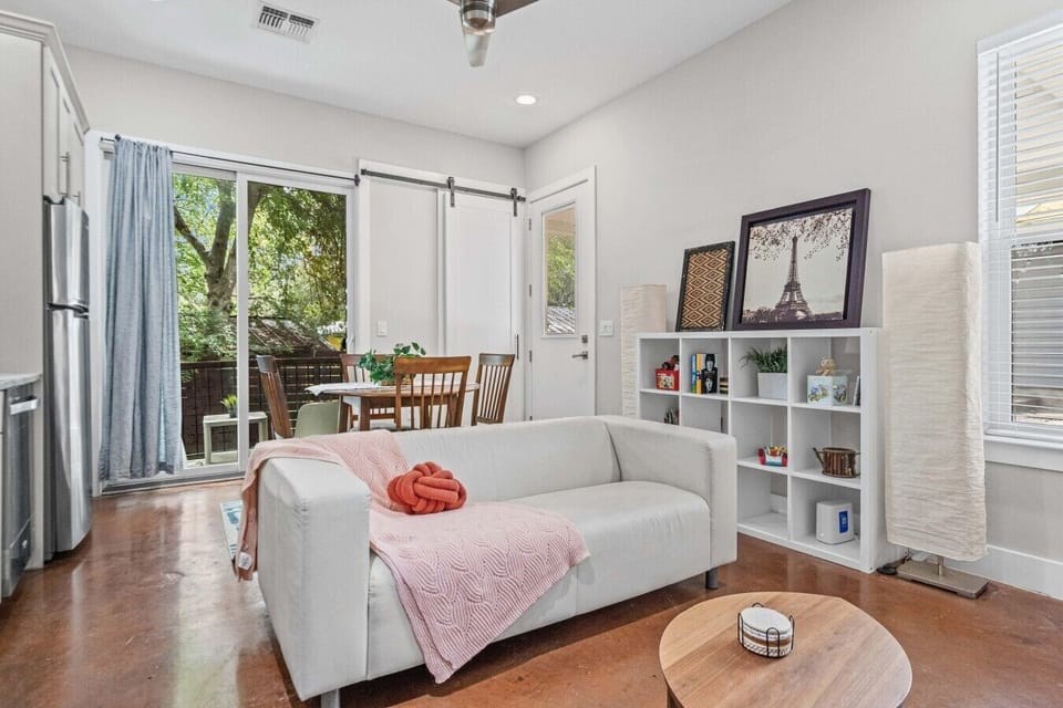 Living and dining flow to a sliding door that opens right onto the private balcony.
